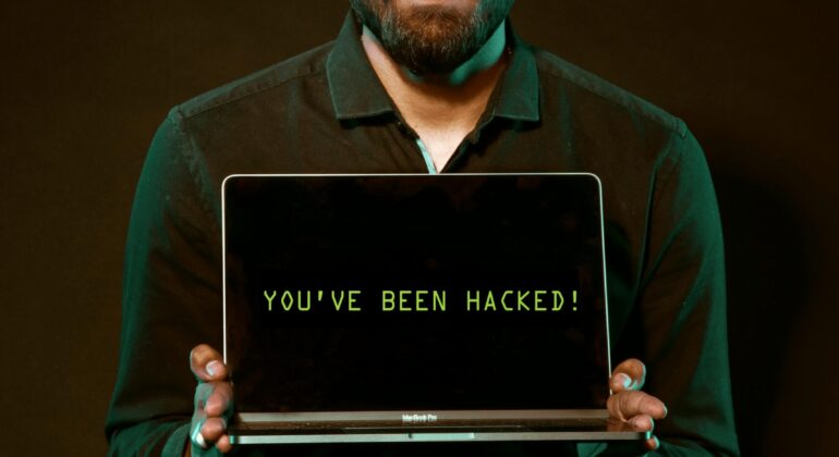 Free Man Holding Laptop Computer With Both Hands Stock Photo