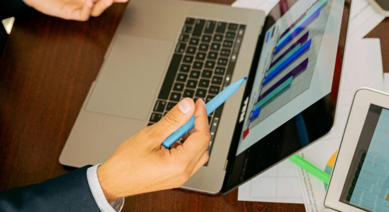 Free A Person in Black Suit Holding a Pen Stock Photo