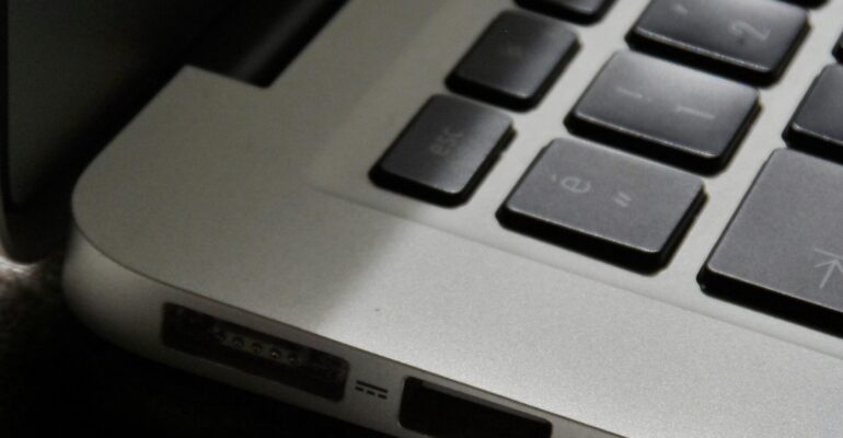 Free Detailed view of a silver laptop showing keyboard and multiple ports. Stock Photo