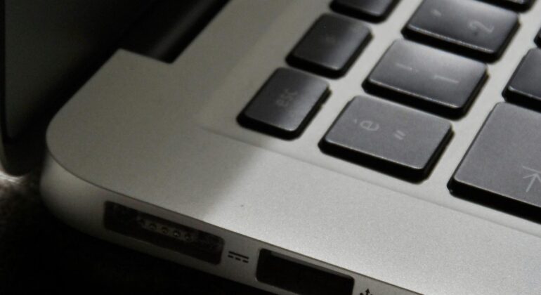 Free Detailed view of a silver laptop showing keyboard and multiple ports. Stock Photo